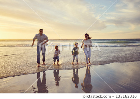 Beach, sunset and parents play with kids on holiday, summer vacation and weekend together. Nature, family and happy mother, father and children run in ocean for bonding, adventure and quality time Beach, sunset and parents play with kids on holiday, summer vacation and weekend together. Nature, family and happy mother, father and children run in ocean for bonding, adventure and quality time 135162316