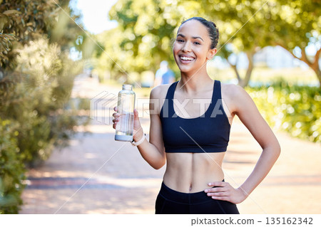 Happy woman, fitness and portrait with water bottle in rest after running, exercise or cardio workout in park. Fit, active and thirsty female person, athlete or runner with smile for sustainability Happy woman, fitness and portrait with water bottle in rest after running, exercise or cardio workout in park. Fit, active and thirsty female person, athlete or runner with smile for sustainability 135162342