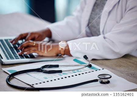 Closeup, hands and doctor with a laptop, stethoscope and typing with connection, documents and telehealth. Black woman, female person or employee with a folder, medical equipment and digital planning Closeup, hands and doctor with a laptop, stethoscope and typing with connection, documents and telehealth. Black woman, female person or employee with a folder, medical equipment and digital planning 135162401