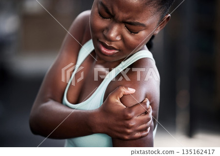 Sports, health and woman with shoulder injury or pain or workout accident and on mockup. Fitness, train and African female athlete with a medical emergency or sprain muscle after a cardio exercise. Sports, health and woman with shoulder injury or pain or workout accident and on mockup. Fitness, train and African female athlete with a medical emergency or sprain muscle after a cardio exercise. 135162417