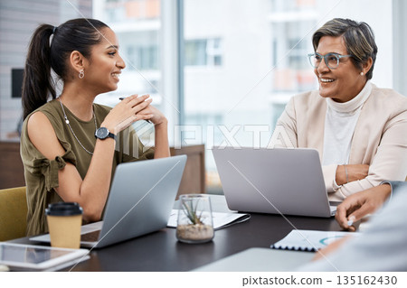Laptop, business and meeting with mentor coaching happy employee in an office planning a teamwork strategy. CEO, staff and professional woman talking with corporate manager for learning discussion 135162430