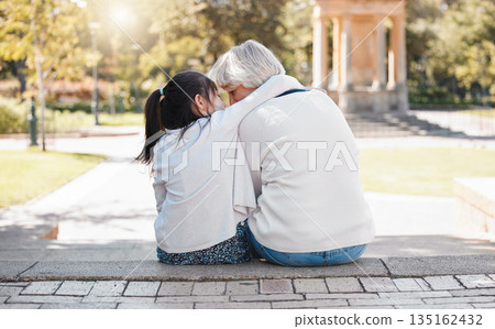 Girl, grandmother and hug in the outdoor for trust or secret in family with grass and sunshine. Kid, hugging and grandma with back of together at the park with a whisper in summer to relax in nature. 135162432