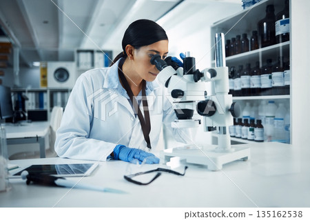Woman, scientist and microscope analysis to check DNA sample with science experiment in laboratory. Female doctor analyze data, scientific innovation and medical research in lab with investigation 135162538