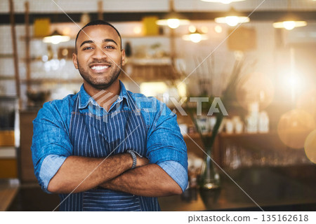 Coffee shop, barista and portrait of happy black man in restaurant for service, working and crossed arms. Small business owner, bistro and professional male waiter smile in cafeteria ready to serve Coffee shop, barista and portrait of happy black man in restaurant for service, working and crossed arms. Small business owner, bistro and professional male waiter smile in cafeteria ready to serve 135162618