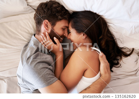 Smile, bed and happy couple hug, relax and spending lazy morning together, bonding and intimacy on Spain vacation. Happiness, marriage and top view of romantic man, woman or people embrace in bedroom 135162620