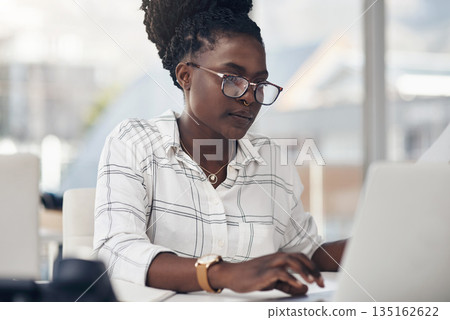 Laptop, typing and business woman for online research, editing or copywriting at her office desk with email. Planning, working and african person, editor or employee on computer for blog or article 135162622