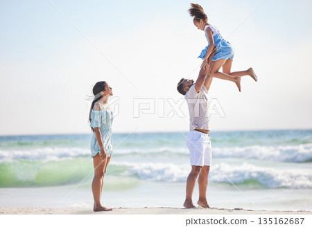 Mother, beach or father playing a girl in air on a family holiday, vacation or weekend break together. Parents, mom or dad swinging or bonding with child, daughter or kid at seaside with happiness Mother, beach or father playing a girl in air on a family holiday, vacation or weekend break together. Parents, mom or dad swinging or bonding with child, daughter or kid at seaside with happiness 135162687
