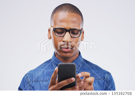 Phone, communication and serious black man in studio typing for social media, internet and online chat. Mockup, white background and male person on smartphone for website, mobile app and network Phone, communication and serious black man in studio typing for social media, internet and online chat. Mockup, white background and male person on smartphone for website, mobile app and network 135162708