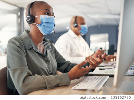 Call center, face mask and a woman at computer with headset for safety compliance or health. African female agent talk at pc for customer service, help desk or crm with covid or bacteria protection Call center, face mask and a woman at computer with headset for safety compliance or health. African female agent talk at pc for customer service, help desk or crm with covid or bacteria protection 135162750