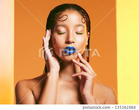 Makeup, cosmetic art and face of woman in studio for cosmetics, eye shadow and beauty salon. Creative aesthetic, cosmetology and female person with blue lipstick for glamour, luxury style and glow Makeup, cosmetic art and face of woman in studio for cosmetics, eye shadow and beauty salon. Creative aesthetic, cosmetology and female person with blue lipstick for glamour, luxury style and glow 135162868