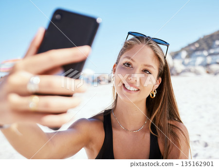 Young woman, beach selfie and smile with beauty, outdoor and summer vacation in sunshine for blog. Girl, happy influencer and photography for travel, social media and sea holiday in Rio de Janeiro Young woman, beach selfie and smile with beauty, outdoor and summer vacation in sunshine for blog. Girl, happy influencer and photography for travel, social media and sea holiday in Rio de Janeiro 135162901