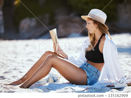 Book, beach and woman reading on summer holiday, vacation or travel in nature outdoor. Relax, novel and person at sand coast for calm break, peace and freedom for enjoying quality alone time in Bali. 135162909