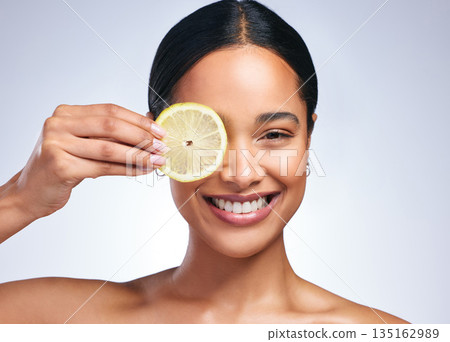 Woman, skincare and lemon in studio portrait with smile, happiness or natural glow on skin by white background. Girl, model and happy for fruit, cosmetics or youth with wellness, nutrition and shine Woman, skincare and lemon in studio portrait with smile, happiness or natural glow on skin by white background. Girl, model and happy for fruit, cosmetics or youth with wellness, nutrition and shine 135162989