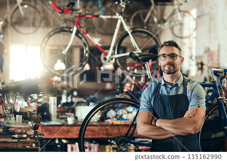 Portrait, serious and repair man in bicycle shop with arms crossed working in workshop. Face, bike mechanic and confident male person, professional or mature technician with glasses in small business Portrait, serious and repair man in bicycle shop with arms crossed working in workshop. Face, bike mechanic and confident male person, professional or mature technician with glasses in small business 135162990