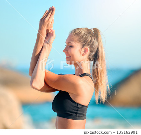 Yoga, meditation and a woman at the beach for zen, wellness or inner peace outdoor in nature. Relax, mindfulness and awareness with a young female yogi meditating against a blue sky for balance Yoga, meditation and a woman at the beach for zen, wellness or inner peace outdoor in nature. Relax, mindfulness and awareness with a young female yogi meditating against a blue sky for balance 135162991