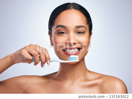 Woman, brushing teeth and studio portrait with smile for self care, dental wellness or health by white background. Girl, dentistry model and toothbrush with toothpaste, product and happy for cleaning 135163022