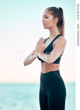 Yoga, namaste and woman at beach, meditation by the ocean with mindfulness, zen with balance and exercise. Female yogi with health, wellness and peace, hands in prayer outdoor and spiritual faith Yoga, namaste and woman at beach, meditation by the ocean with mindfulness, zen with balance and exercise. Female yogi with health, wellness and peace, hands in prayer outdoor and spiritual faith 135163182