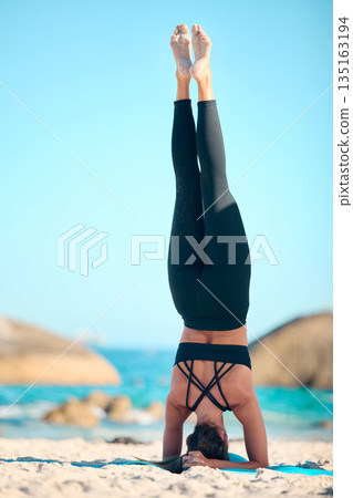 Woman, beach yoga and headstand on sand for fitness, wellness or exercise with peace, nature or freedom. Girl, pilates and workout by ocean for mindfulness, zen and chakra balance in summer sunshine Woman, beach yoga and headstand on sand for fitness, wellness or exercise with peace, nature or freedom. Girl, pilates and workout by ocean for mindfulness, zen and chakra balance in summer sunshine 135163194