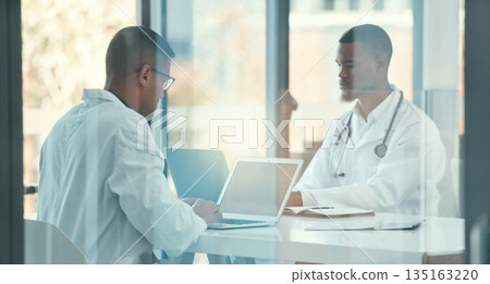 Meeting, laptop and team of doctors for healthcare coworking, discussion and online management. Working, typing and medical people on computer, telehealth and research behind glass window in office 135163220