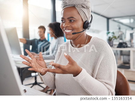 Telemarketing, woman and crm at call centre with communication is happy with headset for online consultant. Customer service, agent and talking at office with a computer with employee at a help desk. Telemarketing, woman and crm at call centre with communication is happy with headset for online consultant. Customer service, agent and talking at office with a computer with employee at a help desk. 135163354
