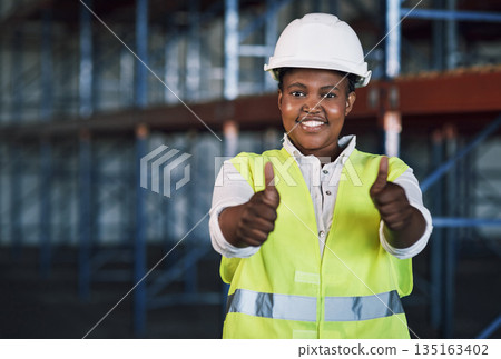 Black woman, architect and portrait with thumbs up in construction for success, good job or winning on site. Happy African female person engineer showing thumb emoji, yes sign or like in architecture Black woman, architect and portrait with thumbs up in construction for success, good job or winning on site. Happy African female person engineer showing thumb emoji, yes sign or like in architecture 135163402