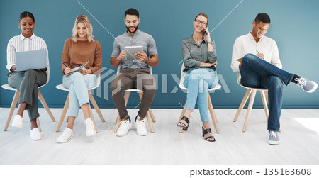 Group, business people and tech by wall for interview with smile, diversity and waiting room for hr recruitment. Men, women and together for networking, human resources and hiring for job at startup 135163608