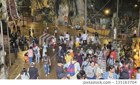 This is cave diorama features golden temples, ritual figures, and natural rock textures, blending Hindu symbolism in Batu Cave inside 135163704