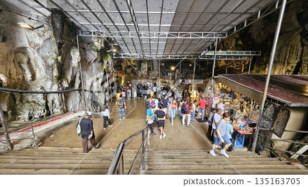 This is cave diorama features golden temples, ritual figures, and natural rock textures, blending Hindu symbolism in Batu Cave inside This is cave diorama features golden temples, ritual figures, and natural rock textures, blending Hindu symbolism in Batu Cave inside 135163705