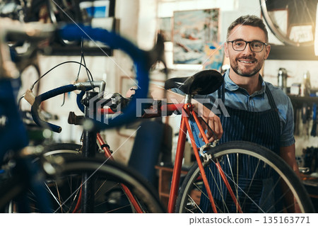Portrait, happy and repair man in bicycle shop for working in store, cycling workshop and startup. Confident bike mechanic, small business owner and mature male technician with glasses in Australia Portrait, happy and repair man in bicycle shop for working in store, cycling workshop and startup. Confident bike mechanic, small business owner and mature male technician with glasses in Australia 135163771