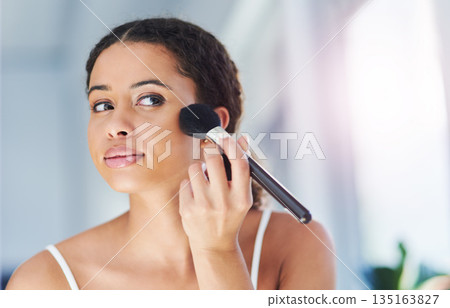 Glamour, makeup and woman with a cosmetic brush for a natural, skin and face in her bathroom. Young, beauty and beautiful female person with cosmetics powder for a morning routine in her apartment. Glamour, makeup and woman with a cosmetic brush for a natural, skin and face in her bathroom. Young, beauty and beautiful female person with cosmetics powder for a morning routine in her apartment. 135163827