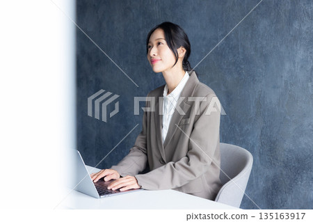 A woman using a computer 135163917