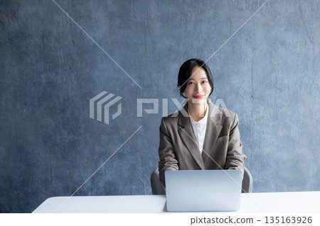 A woman using a computer 135163926