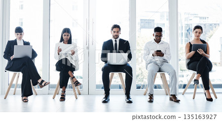 Group, business people and chair with tech in recruitment queue, diversity or waiting room for hr. Men, women and technology for interview, human resources and research for hiring, job or opportunity Group, business people and chair with tech in recruitment queue, diversity or waiting room for hr. Men, women and technology for interview, human resources and research for hiring, job or opportunity 135163927