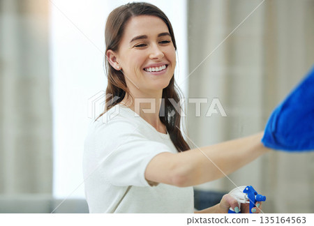 Spray bottle, cleaning window and woman with smile for hygiene, housework and chores at home. Housework, housekeeping and happy female person with detergent, chemical and antibacterial products 135164563