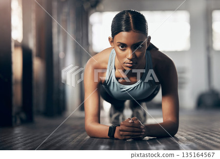 Push ups, training and portrait of woman in gym for challenge, exercise and performance. Health, strong and sports with female bodybuilder and workout in fitness center for energy, wellness or focus Push ups, training and portrait of woman in gym for challenge, exercise and performance. Health, strong and sports with female bodybuilder and workout in fitness center for energy, wellness or focus 135164567