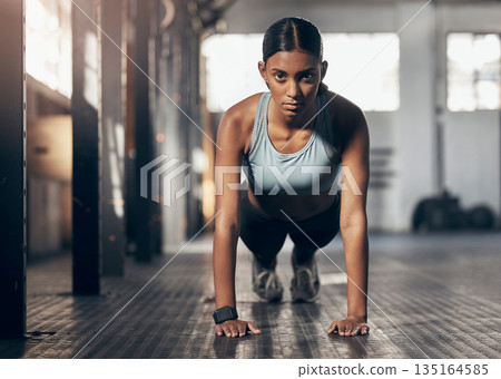 Push ups, challenge and portrait of woman in gym for workout, exercise and performance. Health, strong and sports with female bodybuilder training in fitness center for energy, wellness and focus Push ups, challenge and portrait of woman in gym for workout, exercise and performance. Health, strong and sports with female bodybuilder training in fitness center for energy, wellness and focus 135164585