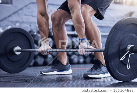 Man, training and lift weight with hands at the gym with legs for wellness with exercise. Male athlete, barbell and workout with hand at a club for strong muscles for lifting the fitness equipment. Man, training and lift weight with hands at the gym with legs for wellness with exercise. Male athlete, barbell and workout with hand at a club for strong muscles for lifting the fitness equipment. 135164682