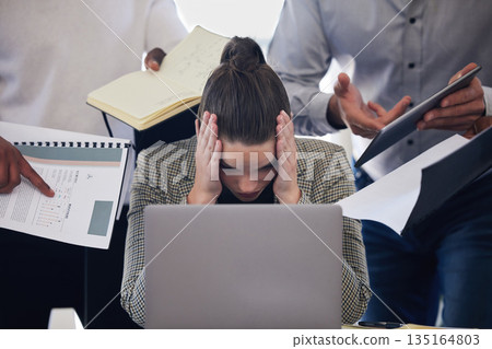Laptop, headache and multitask with a business woman and demanding colleagues working in the office. Stress, anxiety and deadline pressure with an overwhelmed female employee at work on a computer 135164803