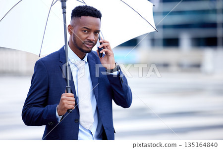 African business man, phone call and umbrella in portrait, street and communication on walk, travel and winter. Black businessman, smartphone and rain in urban metro, cbd and contact for taxi in road African business man, phone call and umbrella in portrait, street and communication on walk, travel and winter. Black businessman, smartphone and rain in urban metro, cbd and contact for taxi in road 135164840