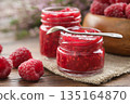 Homemade organic raspberry jam and fresh berries 135164870