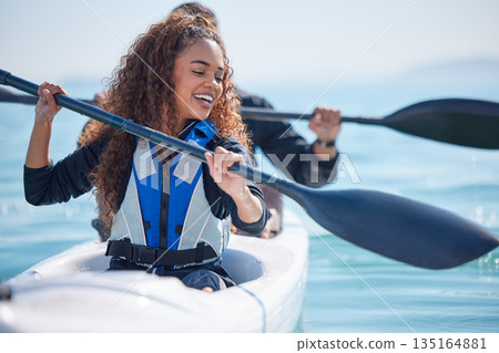 Kayak, woman and rowing boat on lake, ocean or river for water sports and fitness challenge. African girl and partner with paddle for adventure, exercise or travel in nature with freedom and teamwork Kayak, woman and rowing boat on lake, ocean or river for water sports and fitness challenge. African girl and partner with paddle for adventure, exercise or travel in nature with freedom and teamwork 135164881