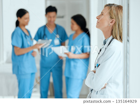 Burnout, anxiety or sad doctor in meeting with nurses with failure, stress or fatigue with medical emergency. Mistake, tired woman or depressed surgeon with depression, trouble or loss in hospital 135164929