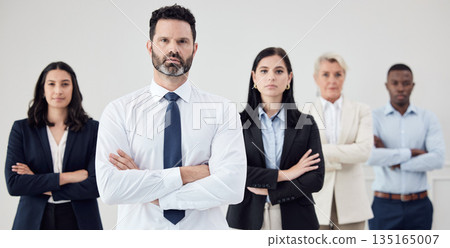 Portrait, leadership and a business man arms crossed with his team in their professional office. Management, collaboration or teamwork with a male boss and colleagues looking confident together 135165007
