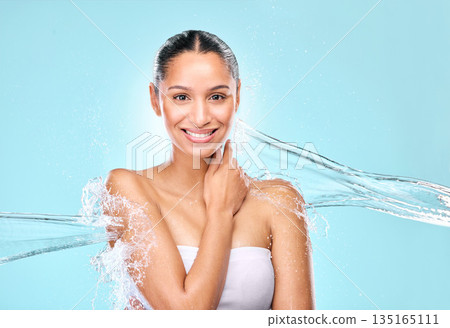 Water, splash and skincare with portrait of woman in studio for hygiene, beauty and shower. Wellness, cleaning and fresh with female model on blue background for spa, cosmetics and mockup space 135165111