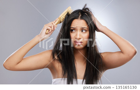 Hair, damage and woman with brush in studio with worry for knots, haircare crisis and weak texture. Beauty, hairdresser and face of female person with frizz, tangle and dry problem on gray background Hair, damage and woman with brush in studio with worry for knots, haircare crisis and weak texture. Beauty, hairdresser and face of female person with frizz, tangle and dry problem on gray background 135165130