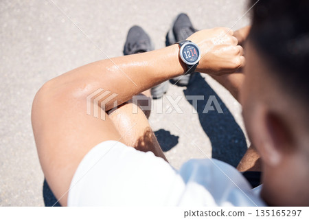 Exercise, smart watch and man in city for time, heart rate and cardio for running, fitness and workout. Wellness, sports and male person check wristband for marathon training, monitor and performance 135165297