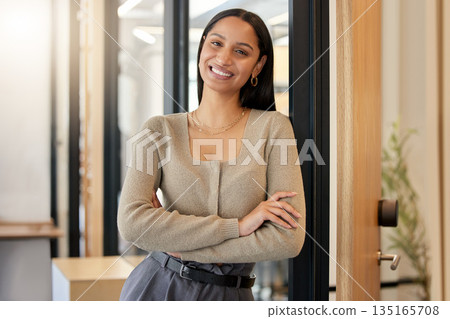Arms crossed, portrait and business woman, designer or professional in office workplace. Face, creative and smile of female entrepreneur or confident design person from India with pride for career. Arms crossed, portrait and business woman, designer or professional in office workplace. Face, creative and smile of female entrepreneur or confident design person from India with pride for career. 135165708