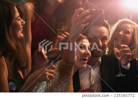 Selfie, party and new year with friends in a nightclub posing for photograph of celebration together. Champagne, toast and nightlife with a group of people taking a picture in a club while dancing Selfie, party and new year with friends in a nightclub posing for photograph of celebration together. Champagne, toast and nightlife with a group of people taking a picture in a club while dancing 135165772