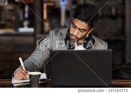 Young business man, writing and cafe with notebook, laptop or plan for schedule, report and analysis. Indian businessman, book and pen for ideas, brainstorming or web design with focus in coffee shop 135165775
