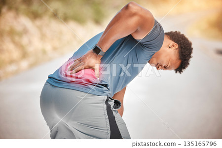 Fitness, back pain and anatomy with a sports man outdoor in nature for cardio or endurance running. Exercise, medical injury or accident with a male athlete holding his body while training for health 135165796